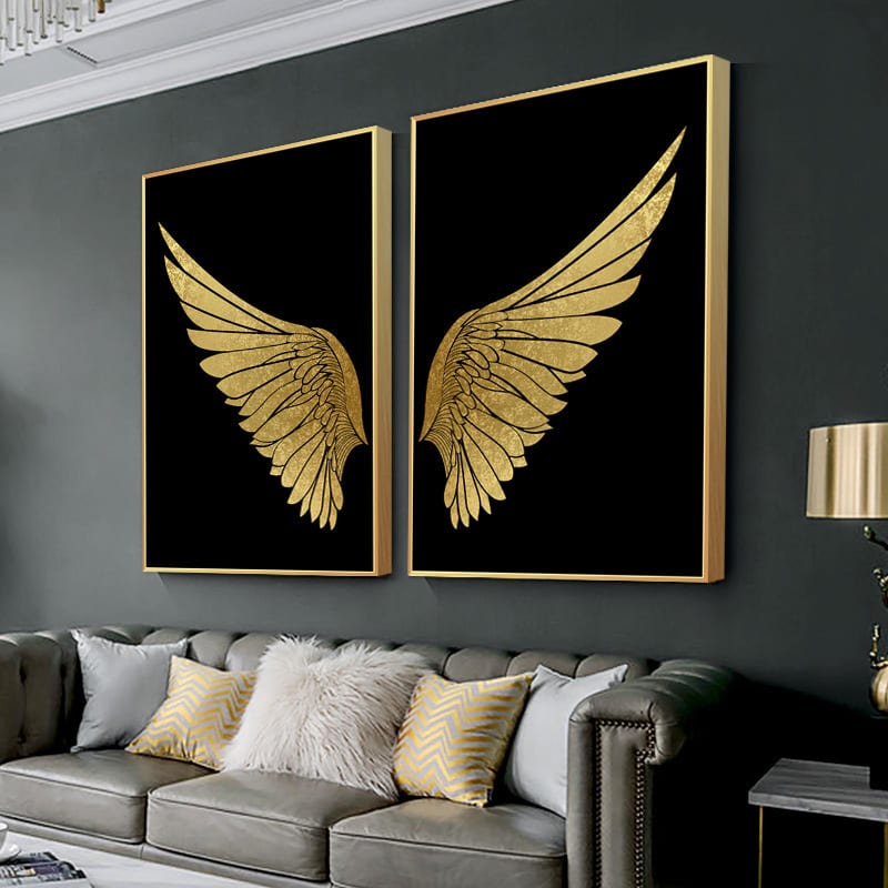 A pair of glossy crystal porcelain gold-wing prints in slim gold aluminium frames hung above a sofa