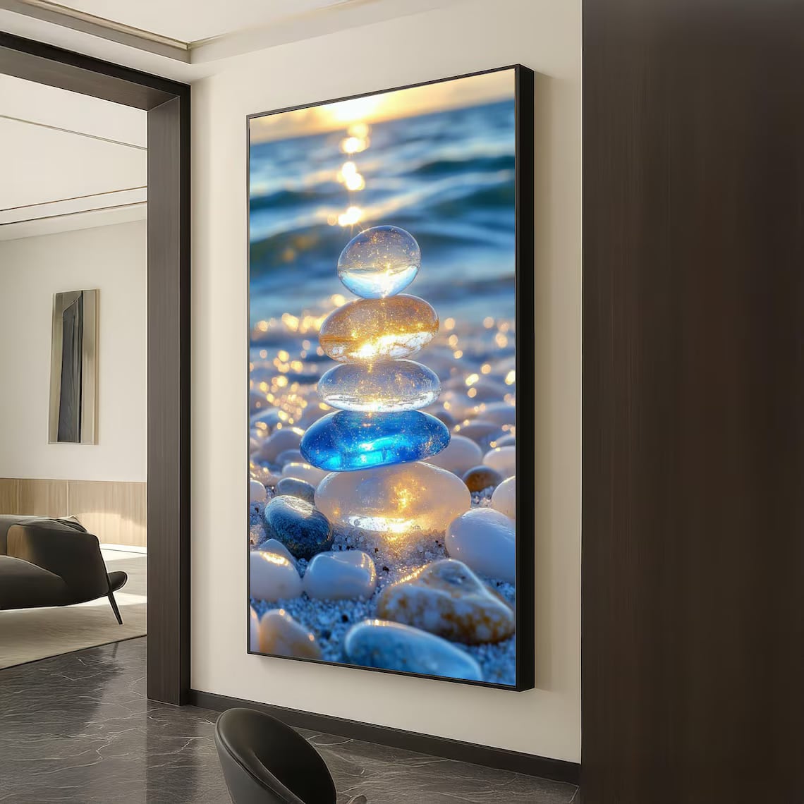 A glossy framed photographic print of glowing beach pebbles at sunset, hung in a modern hallway